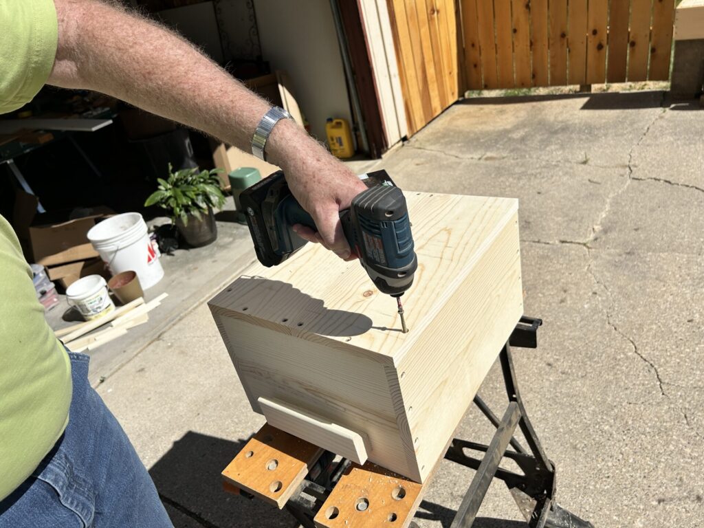 Screwing the bottom onto the Jenga case