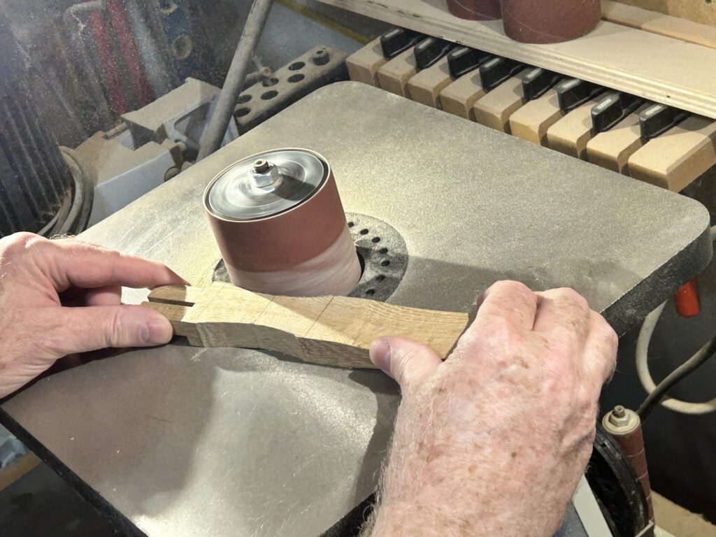 Sanding the relief cuts on the handle at the spindle sander